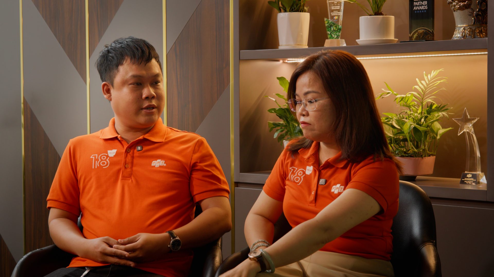 Paired interview with two FPT Telecom employees, one listening as the other speaks